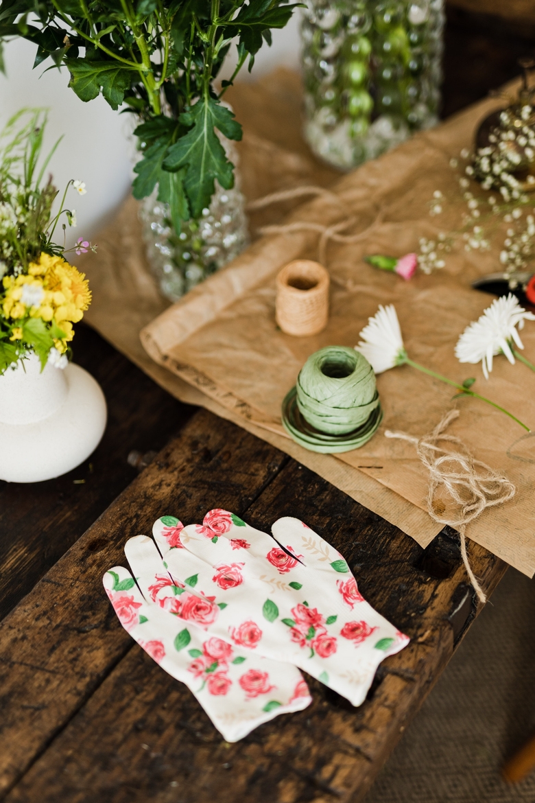 florist gloves on table with bouquets and twine 4466296